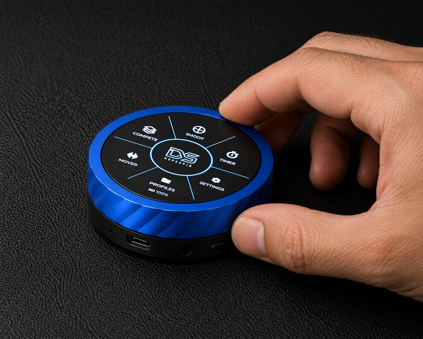 Hand gripping the Dope Spin ballistic dial